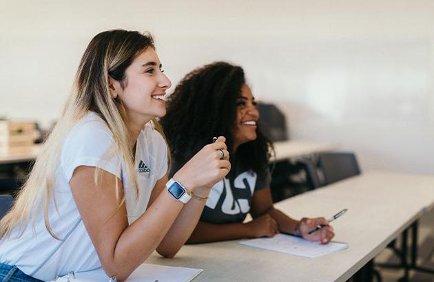 Two female students in a classroom